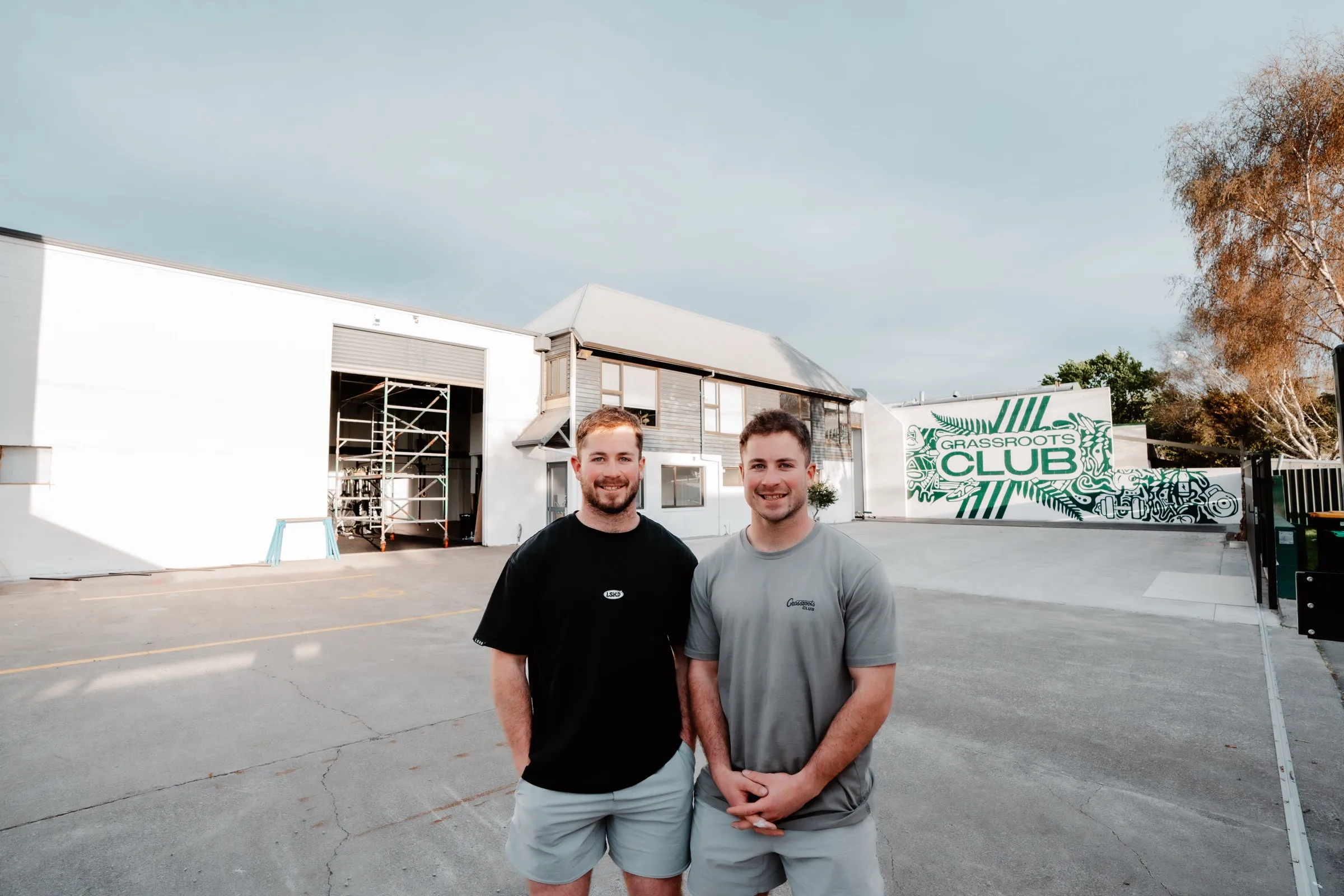 Morgan and Kaden Gibbons, twin founders, outside the Grassroots Club building.